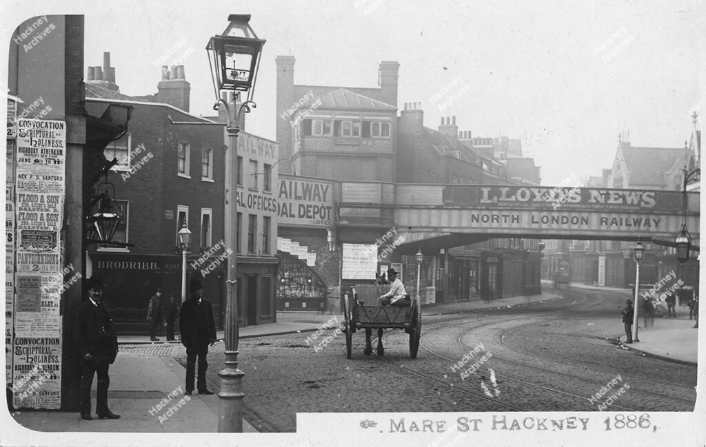 Mare Street, looking south from near Hackney Tower; showing railway coal offices, railway bridge, and Graham Road and Amhurst Road turnings, 1886.