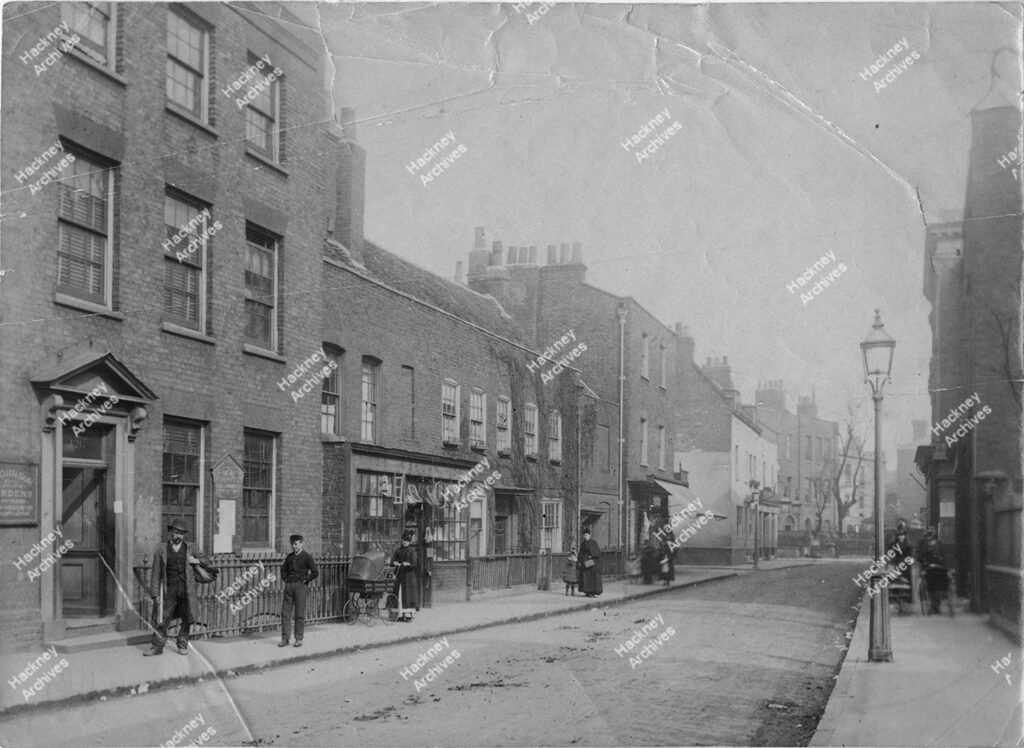 Stoke Newington Church Street looking north east from near Barn Street; showing Lordship Road, the Vestry Rooms (No.126), the Red Lion pub and the Circulating Library, c.1880.