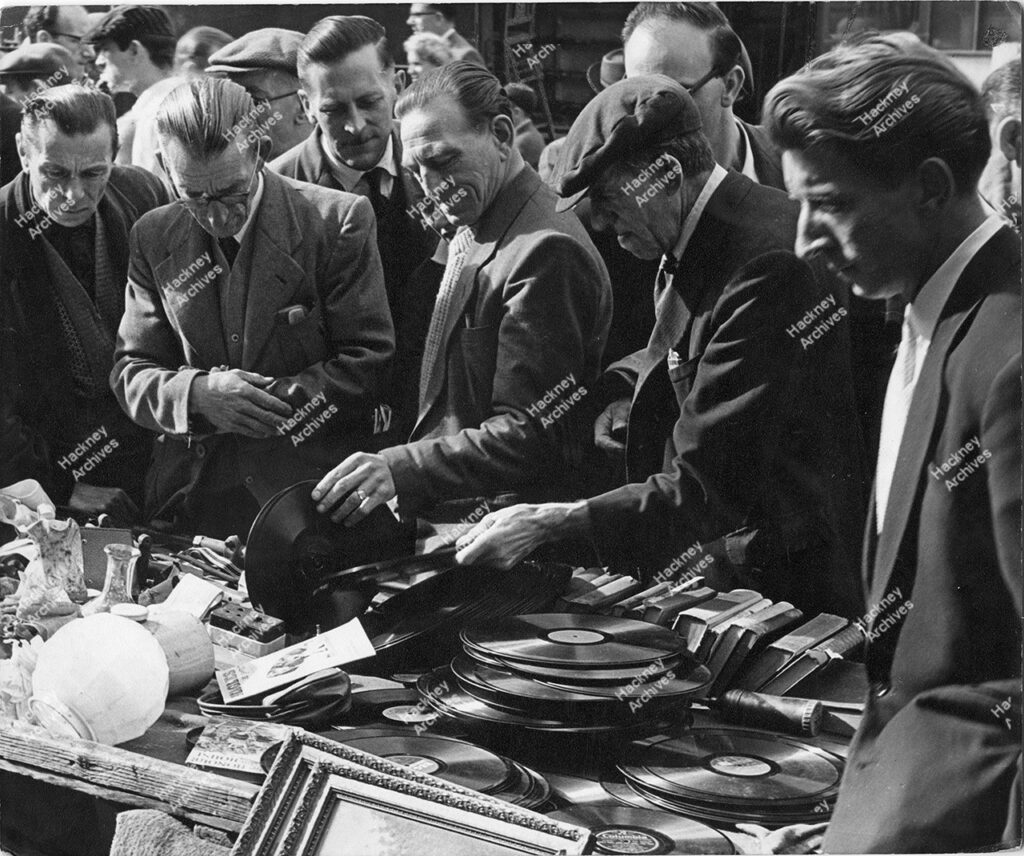 Junk and record stall, street market, Kingsland Road, Hackney. 1962.