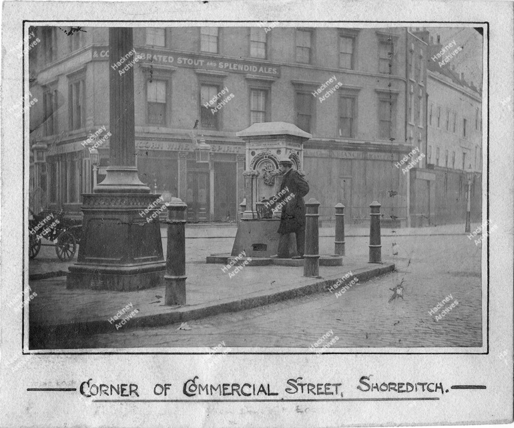 Shoreditch High Street with water fountain in island. Includes The Unicorn public house at the south east of Commercial Street, c.1873.
