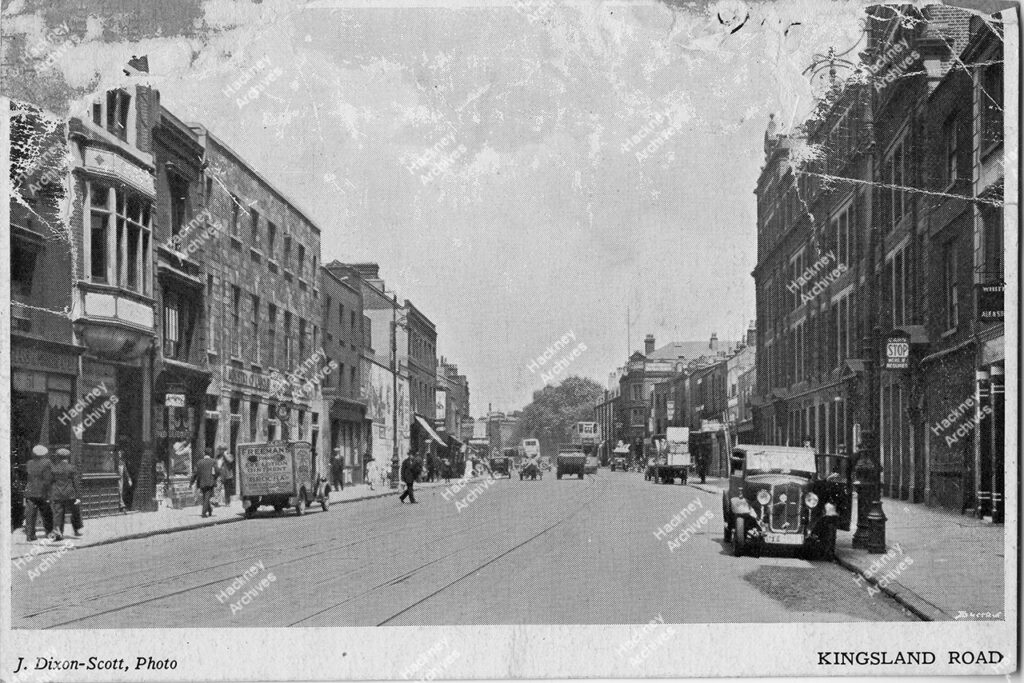 Kingsland road including cars, vans and a tram and a horse drawn cart, Hackney, c.1932.