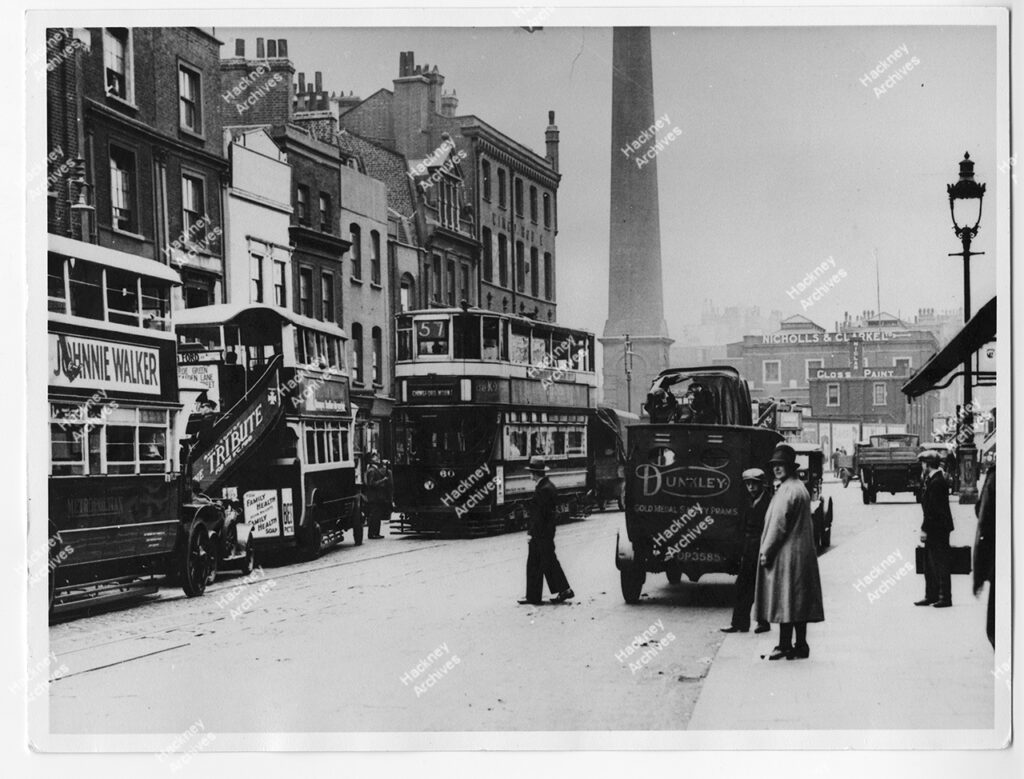 Shoreditch High Street, Shoreditch, Hackney, c.1920. View north towards Nicholls and Clarke LTD. Includes Dunkley gold medal safety prams vehicle.