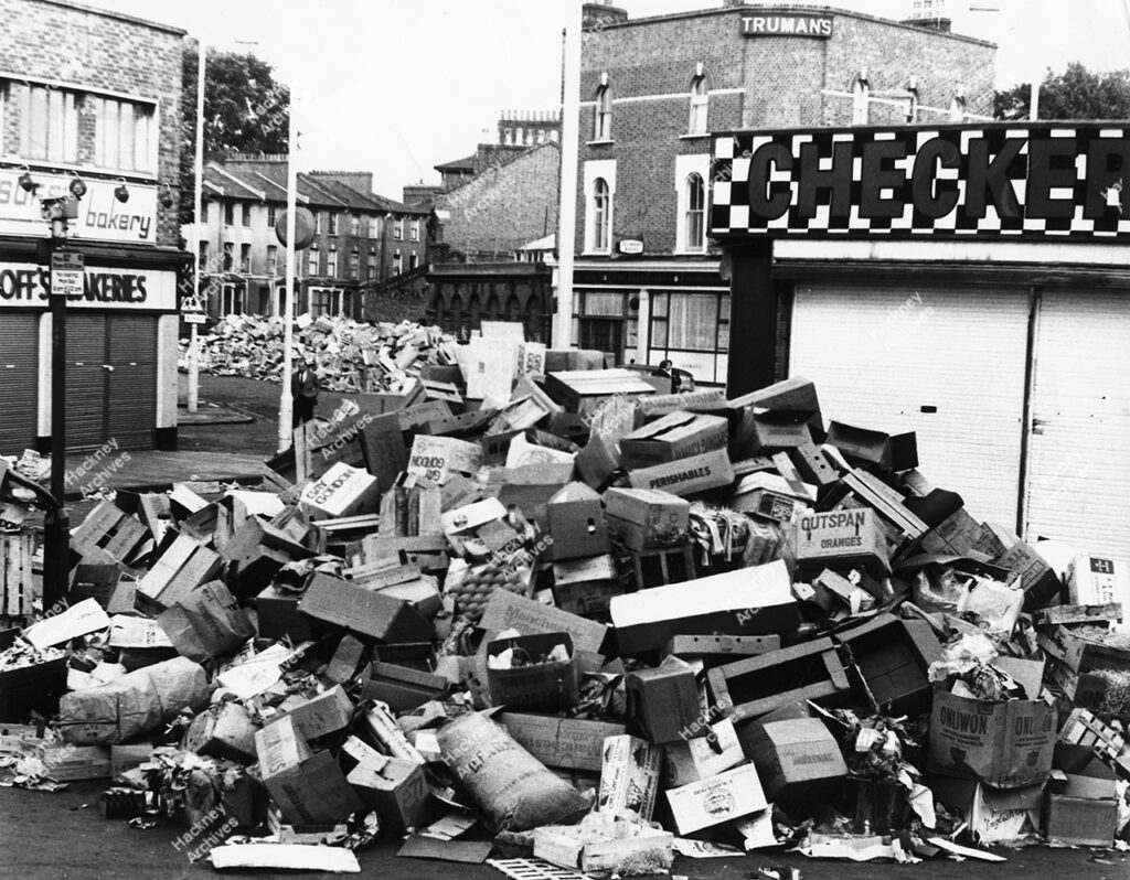 Ridley Road, showing rubbish piles formed during the dustmen’s strike, 1969.