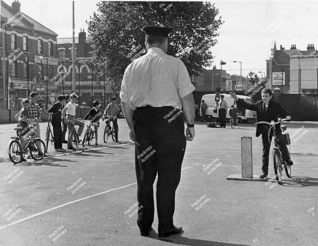Cycling proficiency tests taking place under Metropolitan Police scheme in playground of Princess May School, Stoke Newington, c.1969