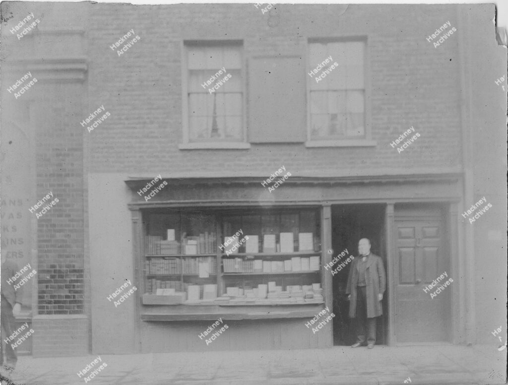 William Harper, Bookseller standing at the door of his shop, No. 32 Tabernacle Walk, 1880.