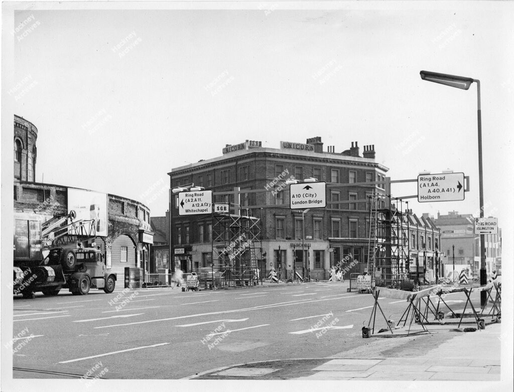 Road works, Shoreditch High Street, Shoreditch, Hackney. 1966. Installation of new road signs and traffic islands on the junction of Shoreditch High Street and Great eastern Street. Includes the Unicorn public house on corner.