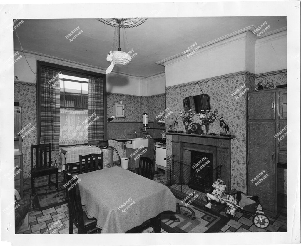 living / sitting room interior at 205 Hoxton Street. Includes kitchen area and dining area in one room. . Late 1950s