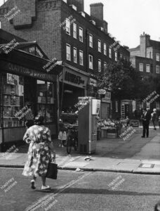 Milk vending machine, outside Clapton Provisions, 109 Upper Clapton Road, looking north of Rossington Street. Includes Morris's groceries, c.1960.