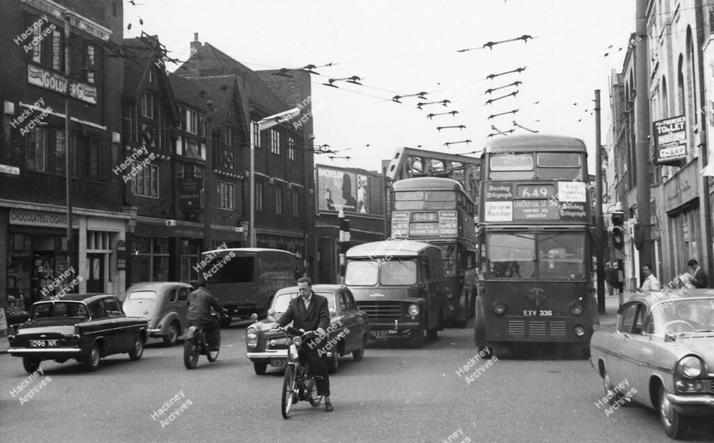 1 -11 Kingsland Road, Hackney. 1961. Includes The Spread Eagle public house and motorbikes, Buses and cars