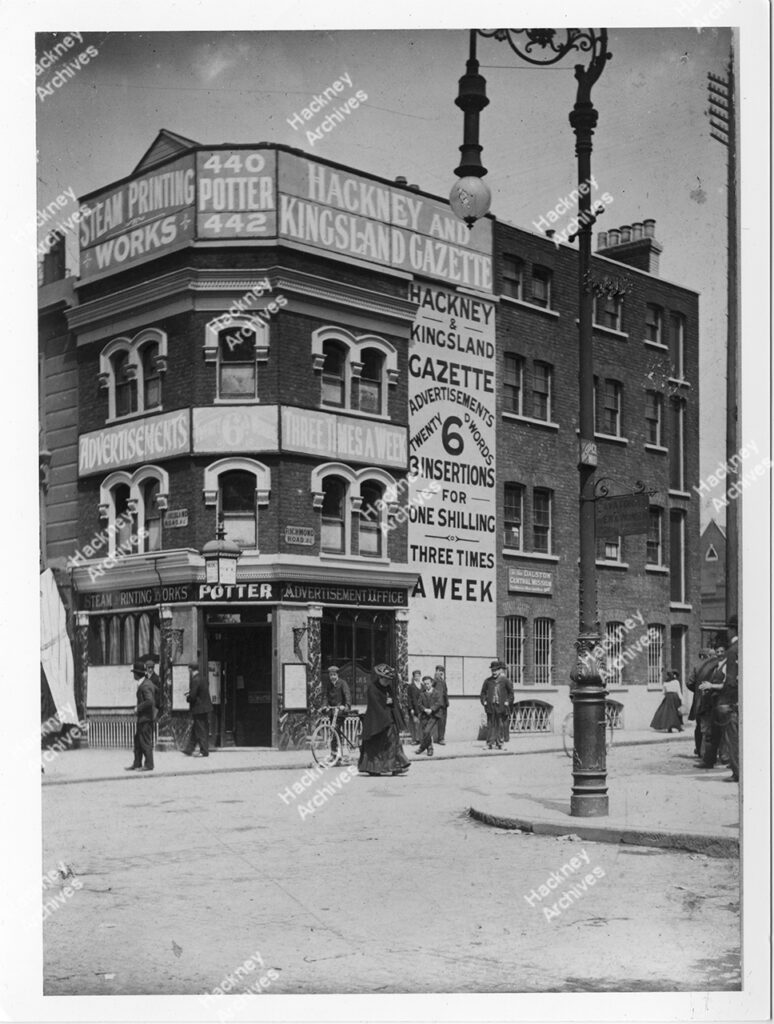 The Hackney Gazette motor delivery van and drivers standing outside Potters Press Limited, corner of Kingsland Road and Richmond Road, c.1925