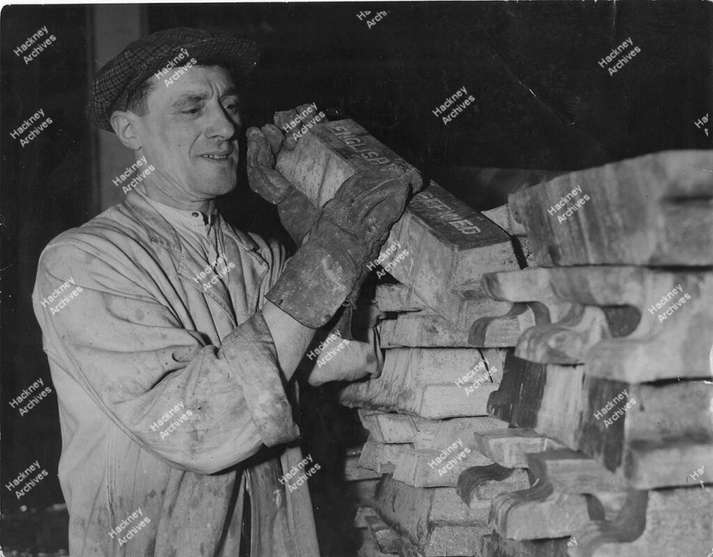 Mr Knowles stacking pigs of lead, Champion Druce & Co, White Lead Mills, southgate Road, De Beauvoir, Hackney, c.1935