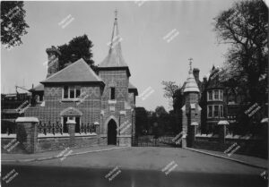 The lodge and main gates at The French Hospital, Victoria Park Road. Scaffolding can be seen to one side of the entrance. 1936