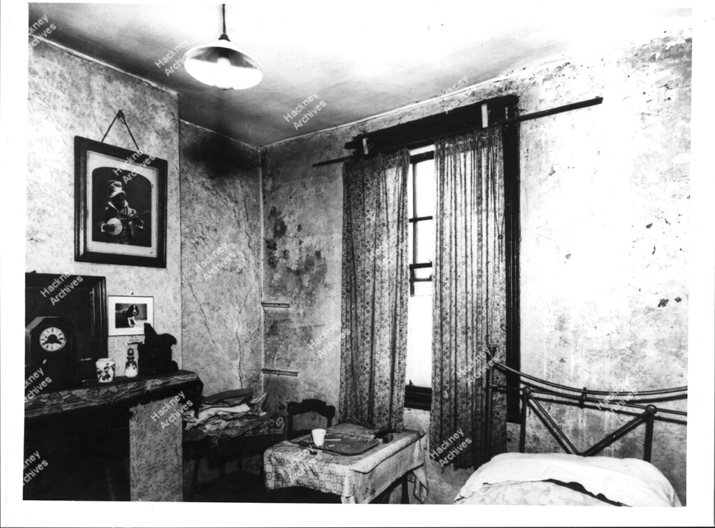 Example of the interior of a slum living room / bedroom, Shoreditch, Hackney, c.1950.