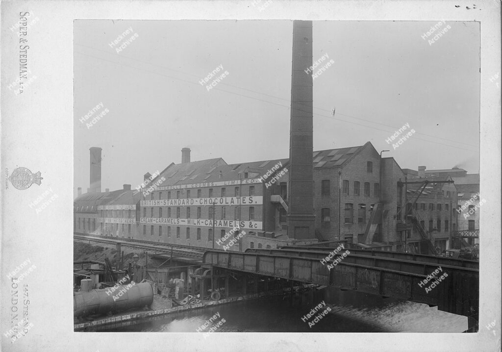 Clarke Nickolls and Coombs Confectionary makers. Views of the works on the west side of the Hackney cut, showing the GER bridge, wharf with barge, one of the yards (north) and a displayroom with product and advertising material, 1896-98.