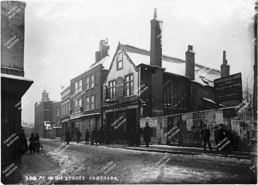 Black and white postcard size image of Homerton High Street, north side looking west from junction with Bridge Street (now Ponsford Street). Includes The Plough public house, G. Grape and pawnbrokers, c.1884.