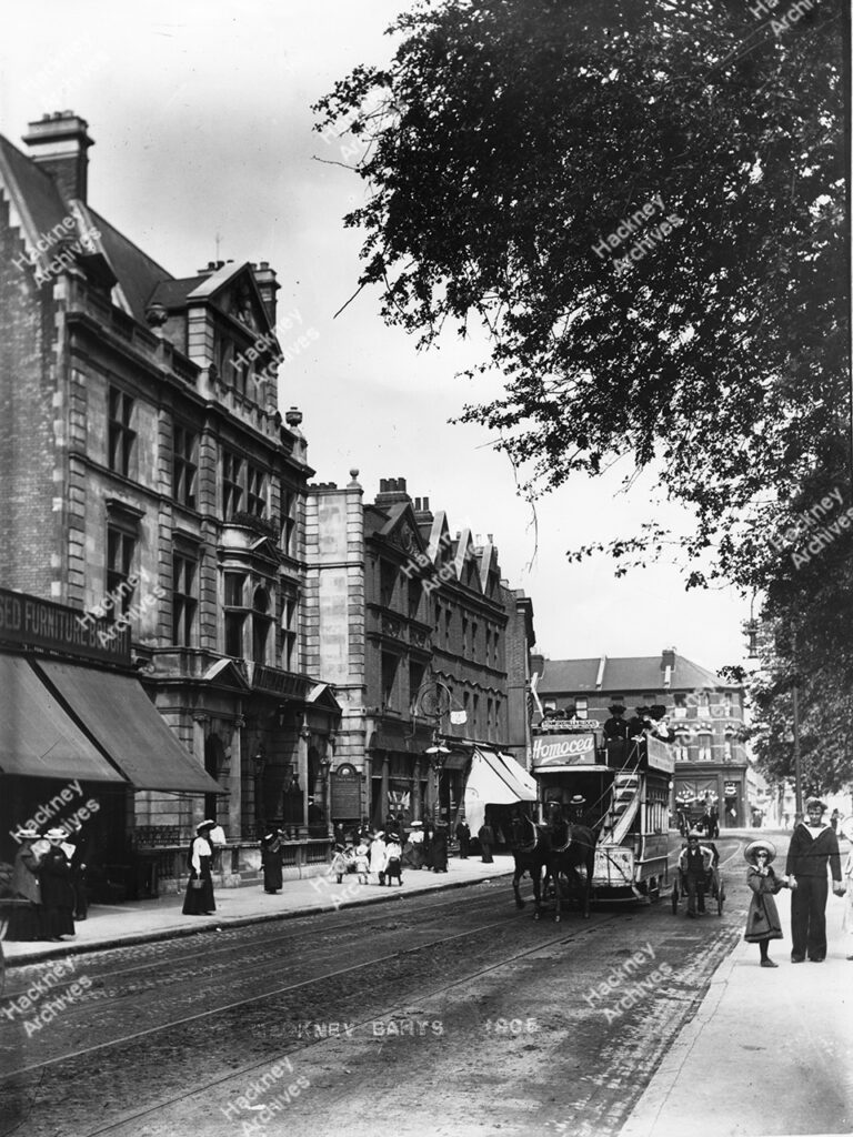 The Kings Hall and baths, Lower Clapton Road, Hackney. 1905. View east to Lesbia Road. Includes a horse drawn tram bus and barrow boy.
