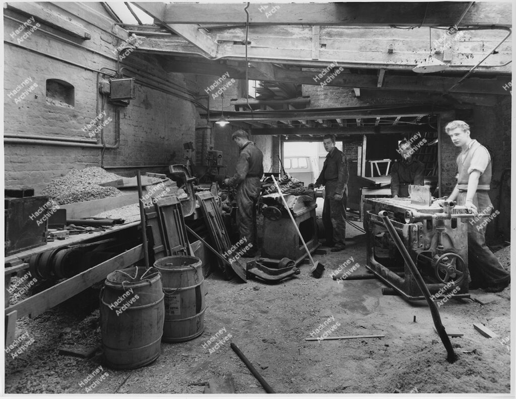 Interior view of industrial timber workshop, 187 New north Road, west side, Shoreditch. Includes men at work, 1955.