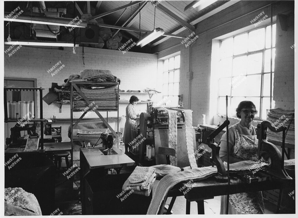Interior of the bedding making workshops of Poplar Bedding Co. LTD, 171-185 Hackney Road / Fellows Street. Includes women at working on the first floor with venting machines. 1960