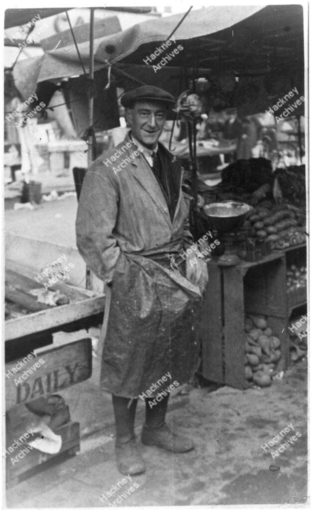 Ridley Road Market.  A.E. Craft standing at his fish stall, 1935.
