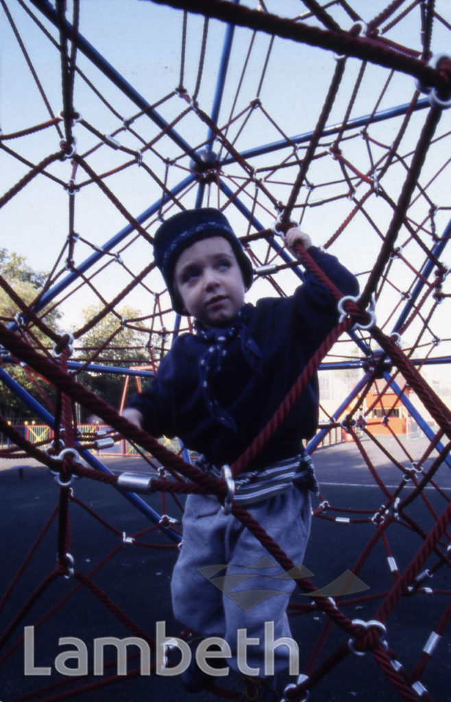 CHILD ON CLIMBING FRAME, COUNCIL PLAYGROUND