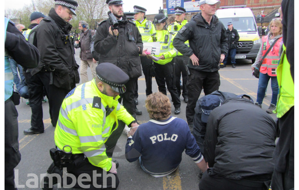 EXTINCTION REBELLION PROTESTER GLUED TO ROAD, VAUXHALL CROSS