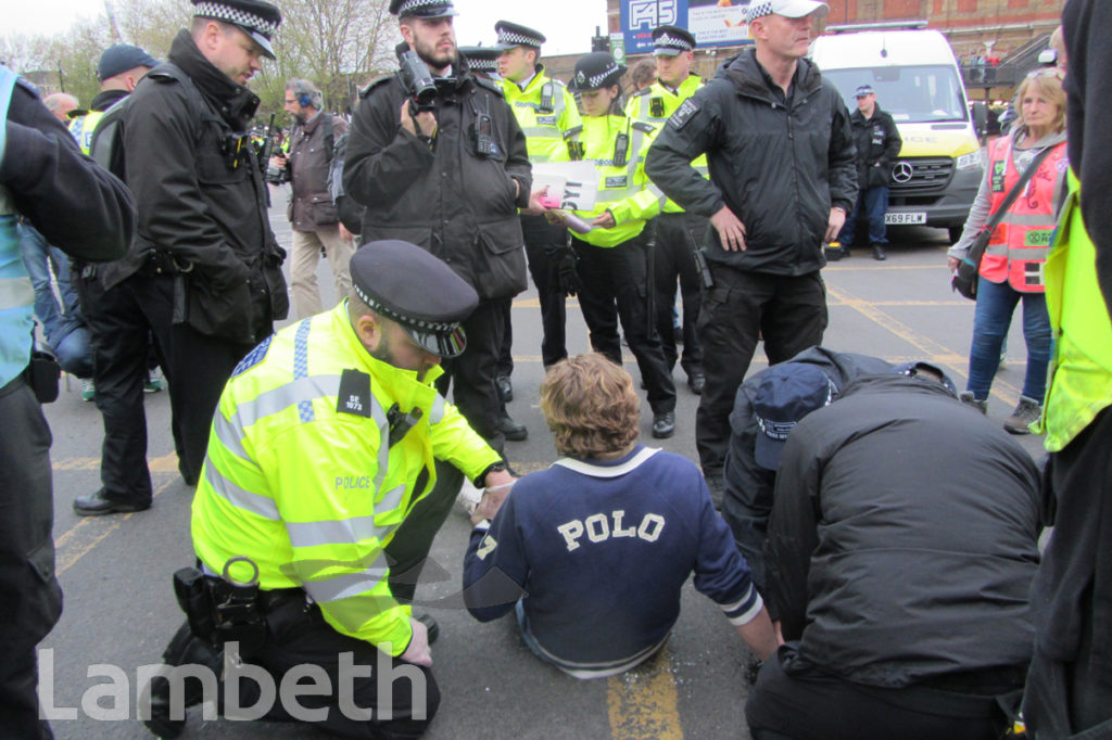 EXTINCTION REBELLION PROTESTER GLUED TO ROAD, VAUXHALL CROSS