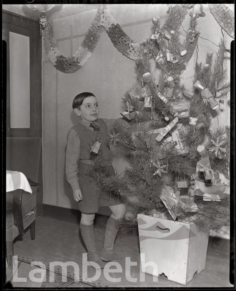 FRANK MANNING WITH FAMILY CHRISTMAS TREE